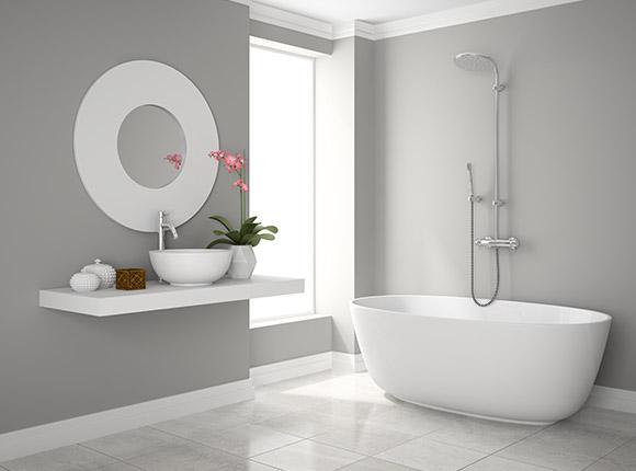 Bagno minimalista sui toni del bianco e grigio